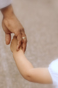 Father holding daughter's hand image